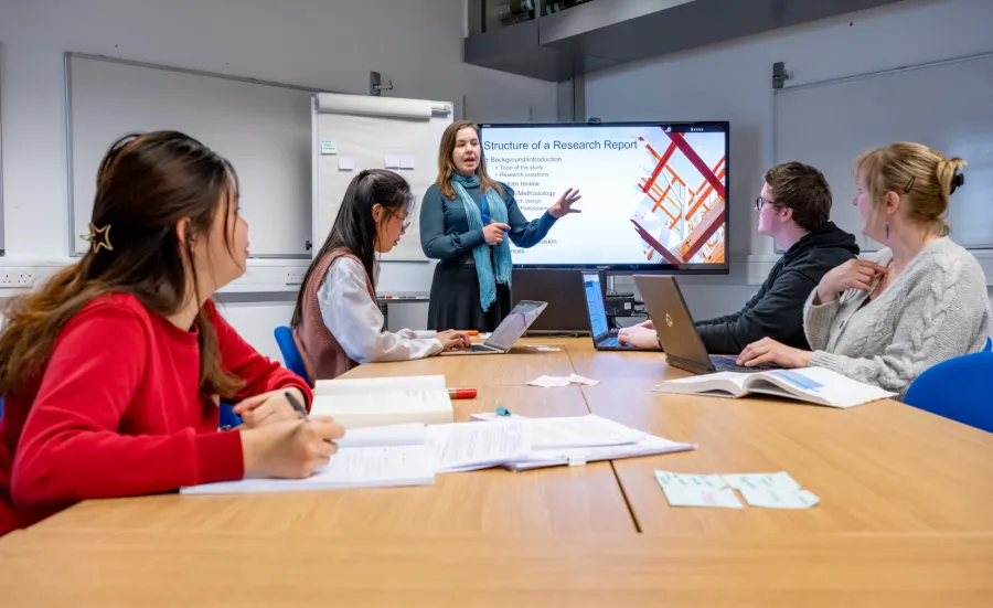 Students of different ages and ethnicities preparing for a research proposal